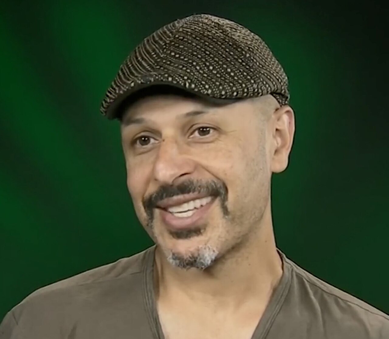 Portrait of Maz Jobrani being interviewed at Voice of America — diaspora comedy icon and reference point for bilingual hosting craft.